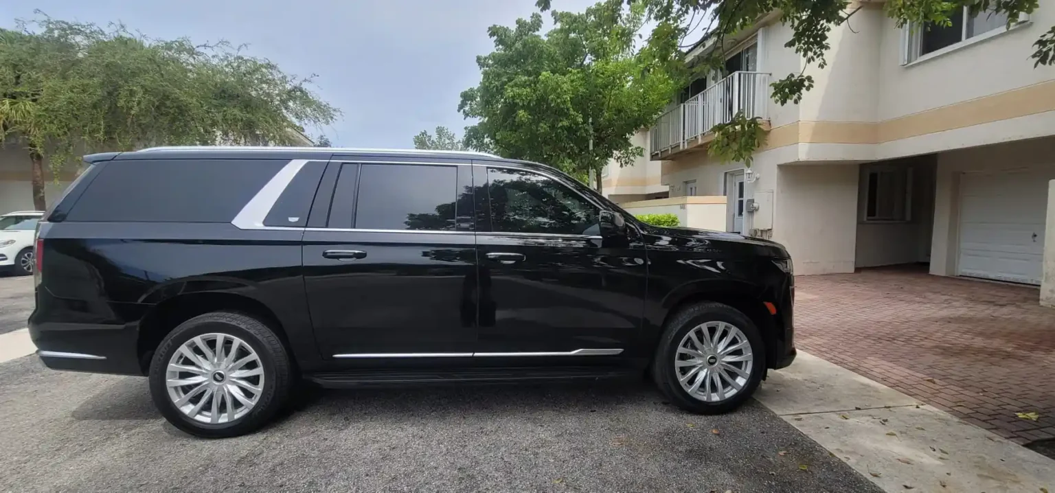 Black luxury SUV parked in front of townhomes